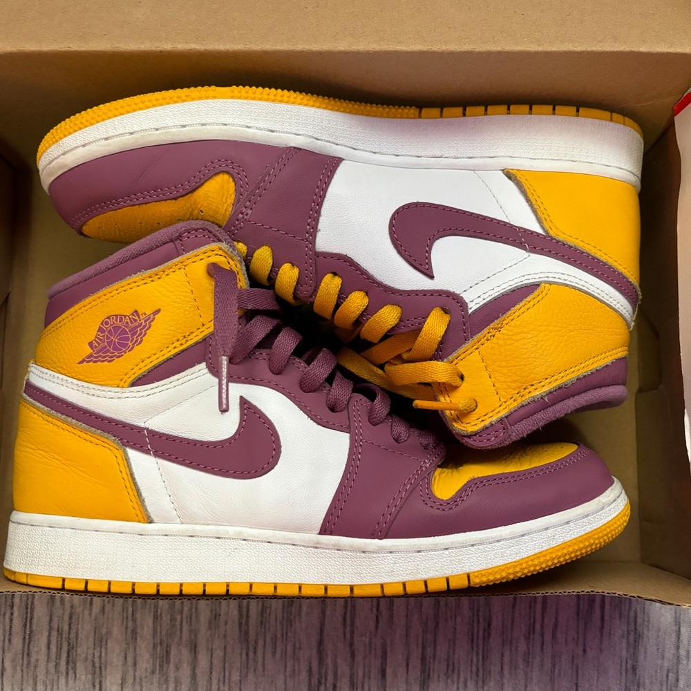 These are Nike high dunks that are gold and purple.